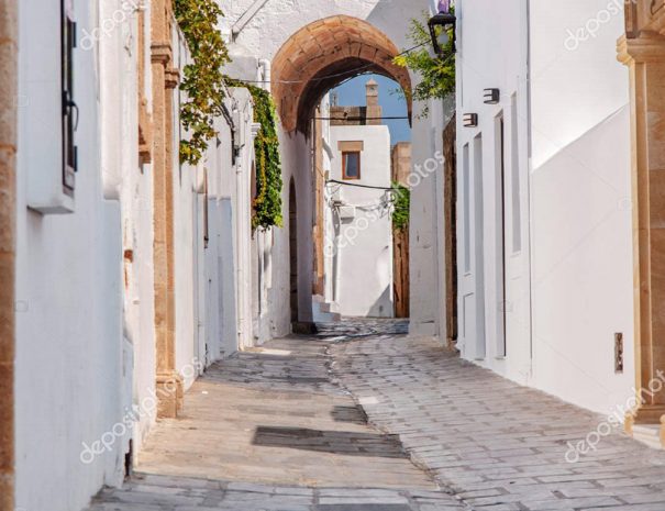 Small narrow alley in Greek old beautiful town Lindos at island Rhodes